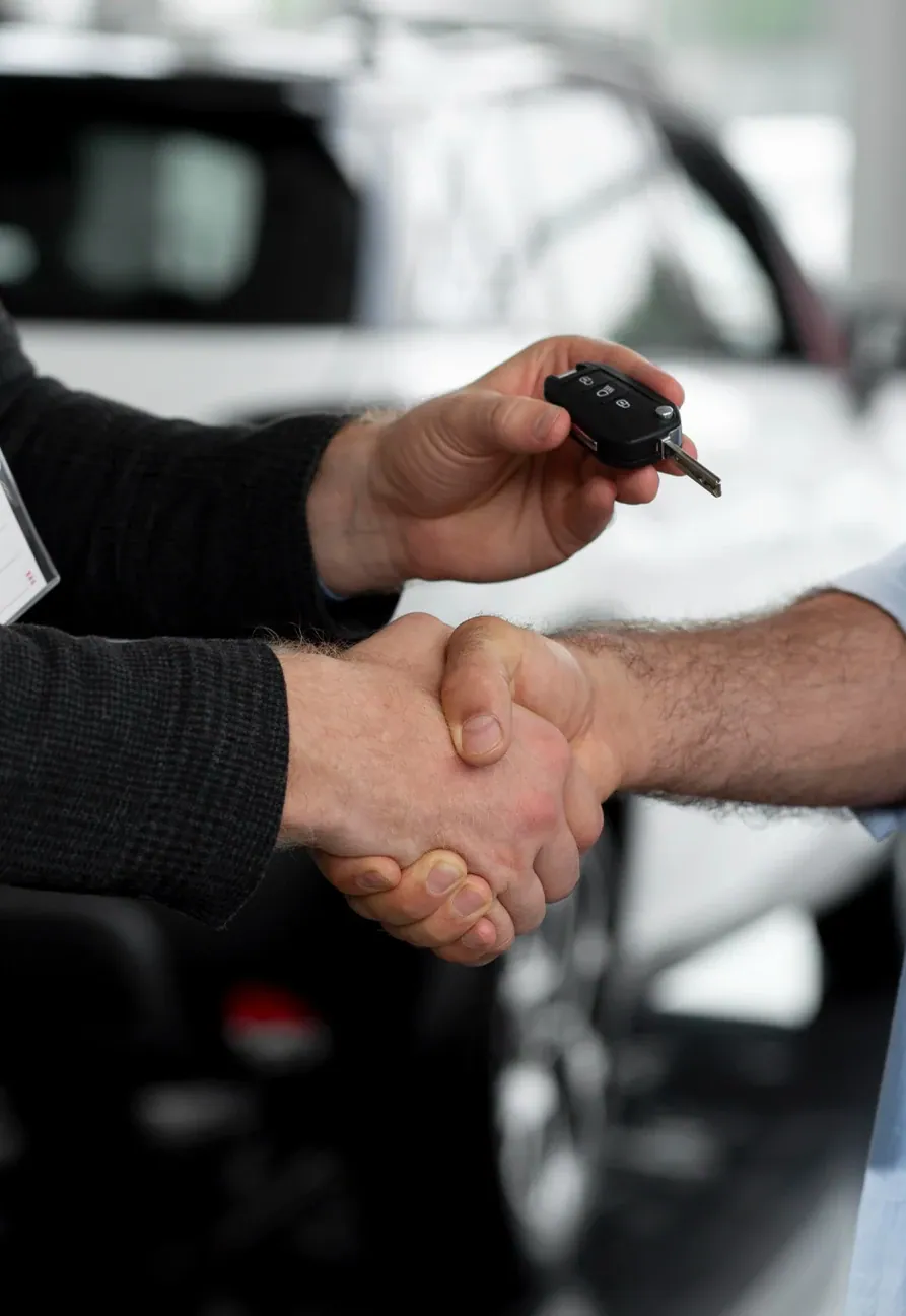 A handshake over a car key
